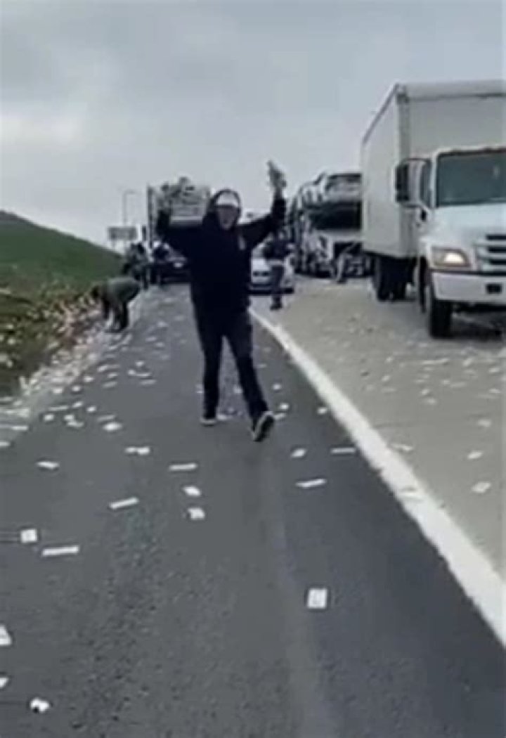 Millions Of Dollars Fall Out Of Bullion Van After Doors Burst Open, Many Park Their Cars To Pick Them On The Streets (VIDEO)