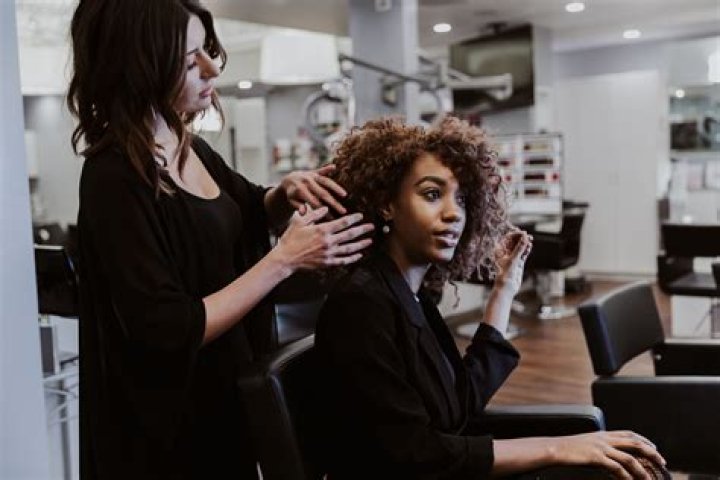 Reactions As Photos From Barbering Shop Where Ladies Sit On The Laps Of Male Customers To Serve Them Hit Online